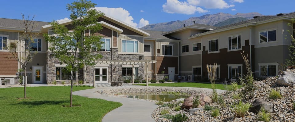 Exterior view of Covington Senior Living with landscaped garden