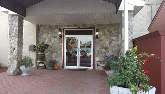 Front entrance of Darlington Memory Lane with stone pillars and potted plants