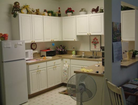 Inside view of a kitchen area with cabinets and appliances