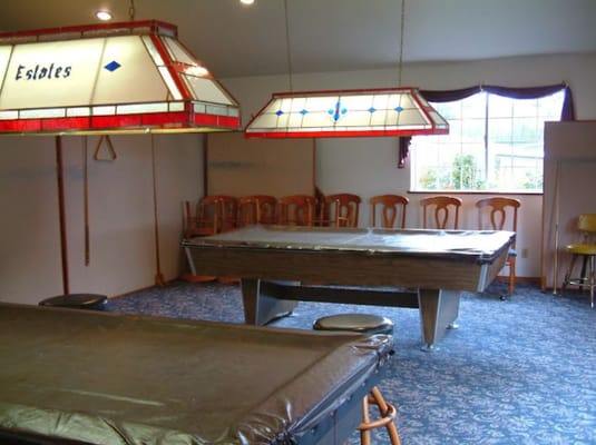 Interior view of a game room with pool tables