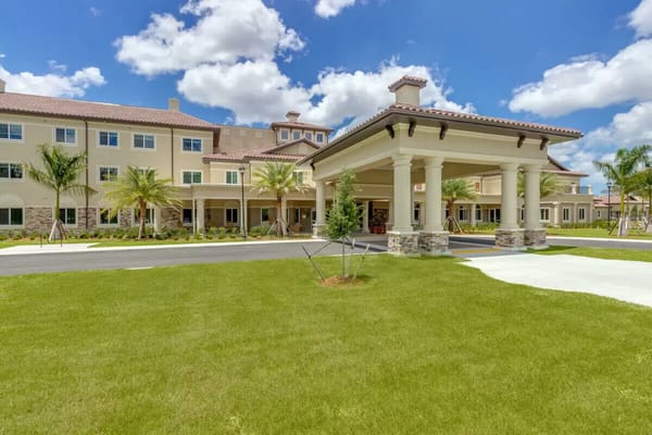 Exterior view of a senior living facility with manicured lawn