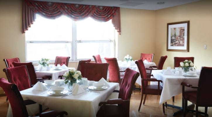 Dining room set up with tables and flowers