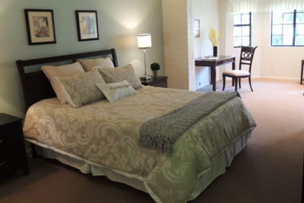 Well-furnished private resident room with a bed and desk