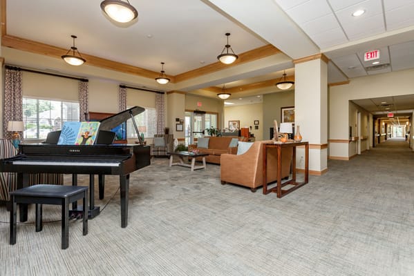 Spacious living room with a piano and seating area
