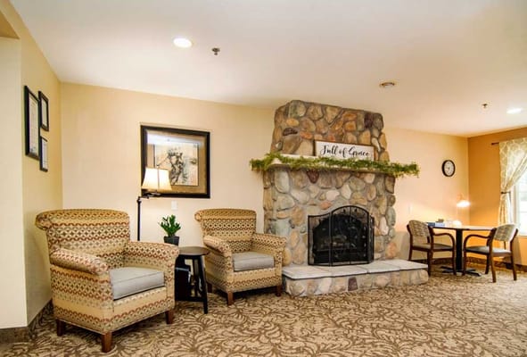 Inviting living area with stone fireplace and comfortable chairs