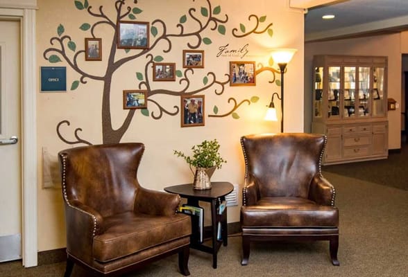 Cozy seating area with a family tree mural in the lobby