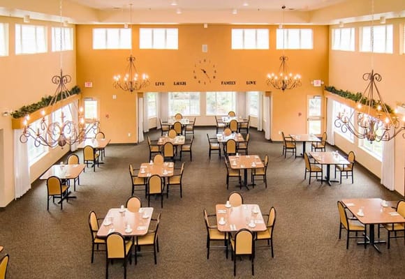 Interior view of dining room with tables and chandeliers.