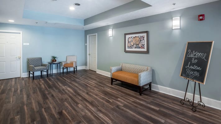 Bright common area with seating and welcome sign