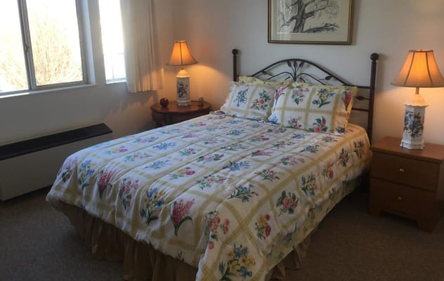Cozy resident room with floral bedding and lamps
