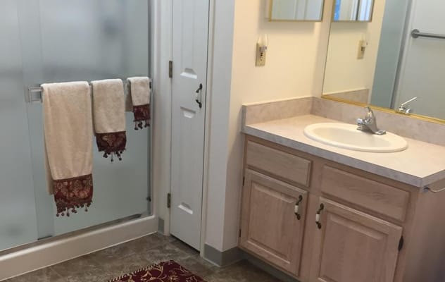 Bright bathroom in a resident room with towels