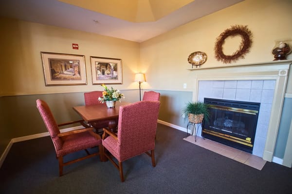 A cozy common area with a fireplace and seating