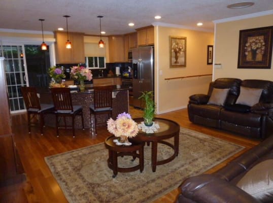 Inviting kitchen and living room area with seating and floral decor