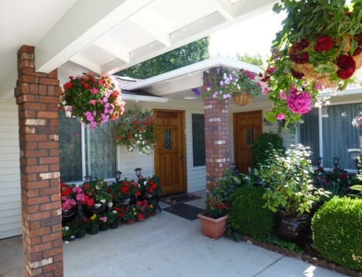 Colorful flower arrangements at the entrance of Fit Adult Care Home.