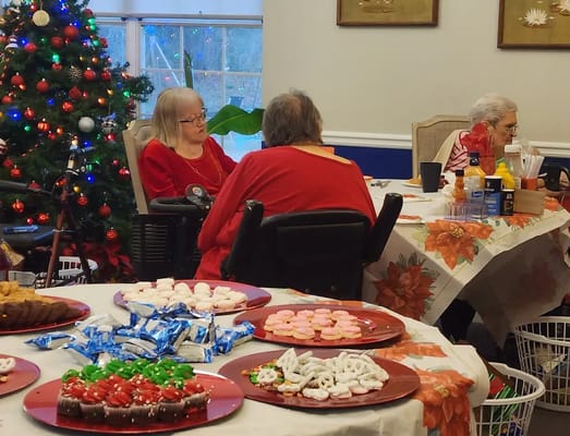 Residents enjoying a festive gathering with treats and decorations.