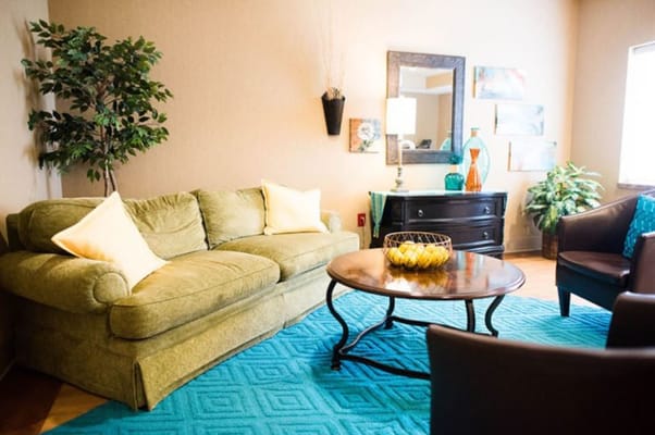 Cozy lounge area with green sofa and decorative elements