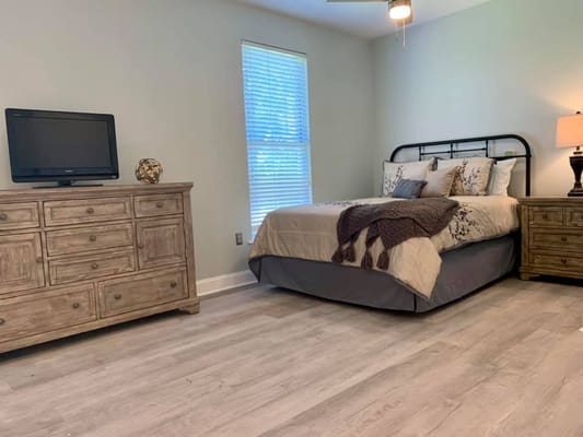A cozy private resident room with a bed and furniture