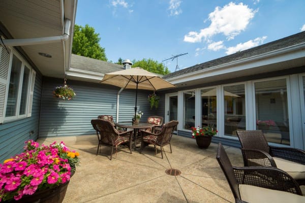 Outdoor patio area with seating and flowers