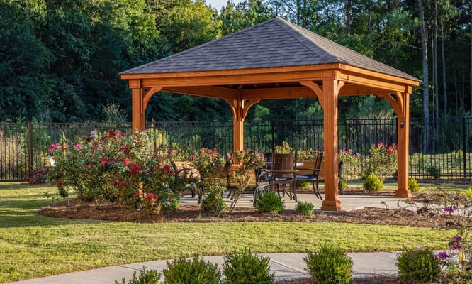 A gazebo surrounded by flowers in a garden