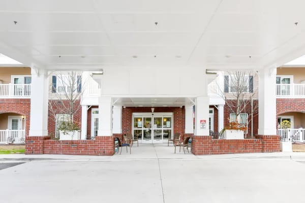 Entrance of a senior living facility with seating area