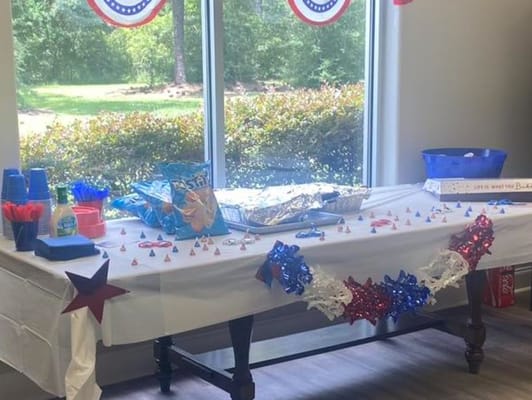 Decorative table setup for a celebration with food and drinks