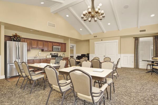 Spacious activity room with tables and chairs