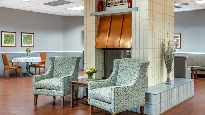Interior common area with seating and a fireplace