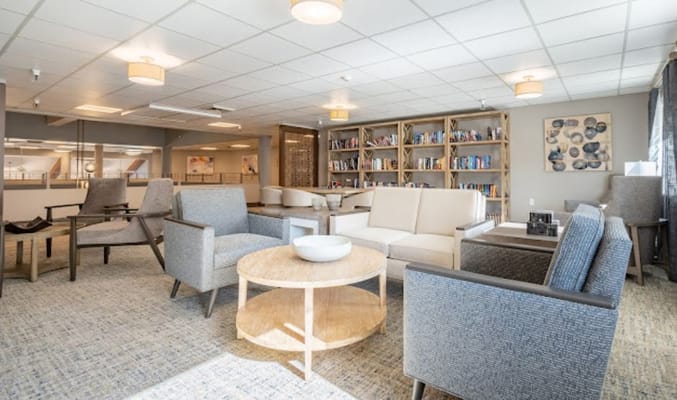 Welcoming common area with seating and bookshelves