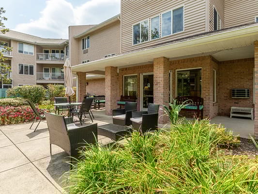 Outdoor patio area with seating and landscaping