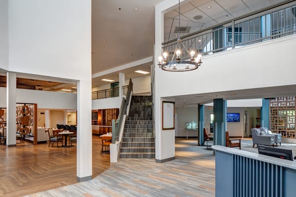 Interior shot of a nursing home common area with staircase