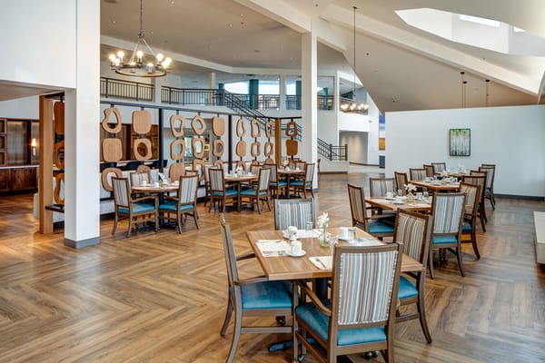 Bright dining room with tables set for meals