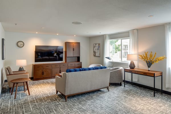 Bright common area with comfortable seating and a TV