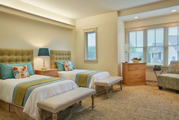 Cozy resident room with twin beds and natural lighting