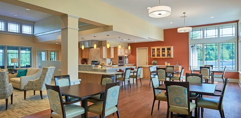 Bright and spacious common area with dining tables