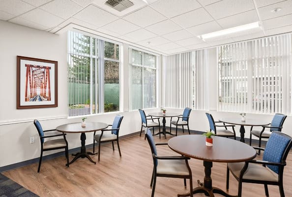 Bright common area with tables and chairs