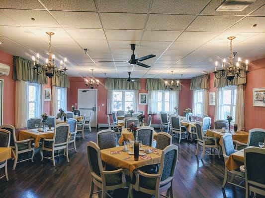 Dining room with tables set and chandeliers