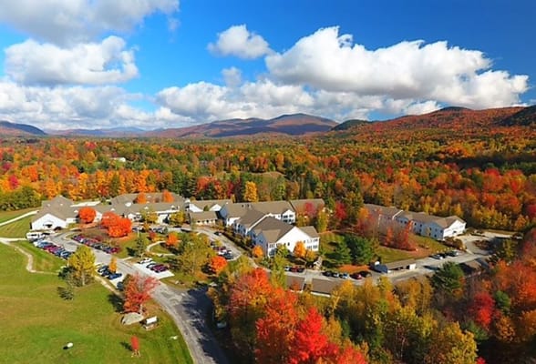 Aerial view of a senior living campus surrounded by autumn trees
