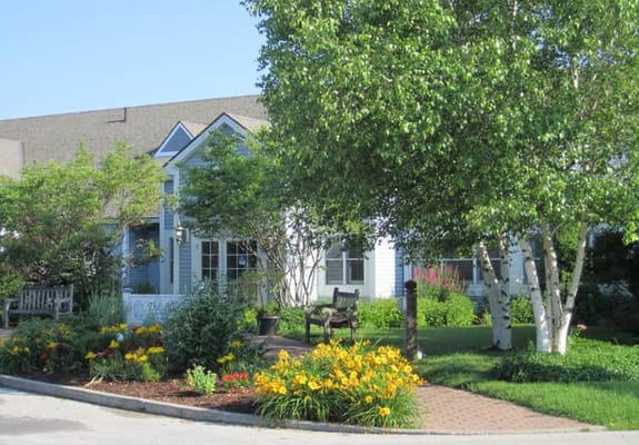 Exterior view of assisted living facility with landscaped garden