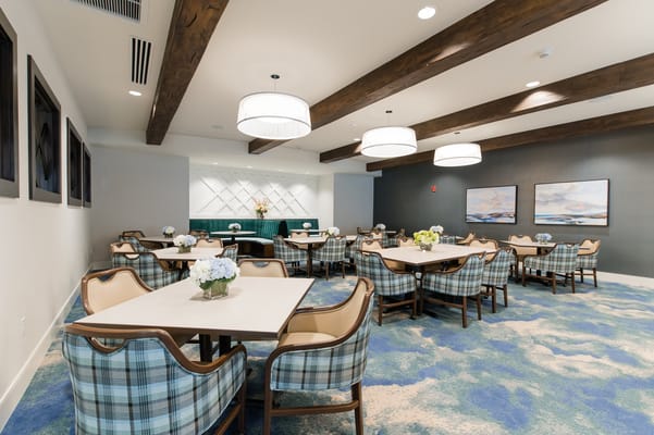 Bright and spacious dining room with tables and chairs