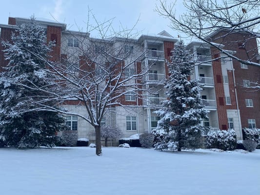 Exterior view of a snowy assisted living facility