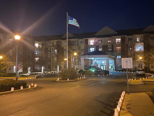 Exterior view of Moravian Village at night with flag