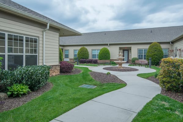 Beautiful landscaped outdoor space with benches and fountain