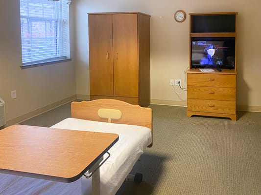 Interior view of a resident's private room with furniture