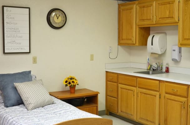 Cozy resident room with kitchen area and sunflowers