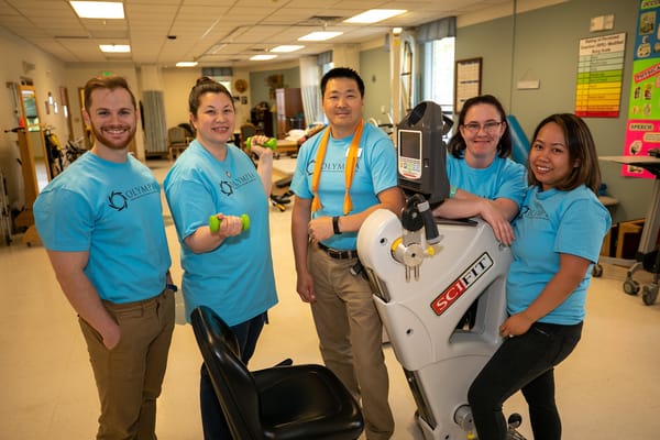Staff members engaging with rehabilitation equipment