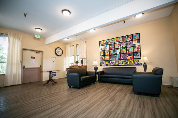 Bright common area with seating and colorful artwork