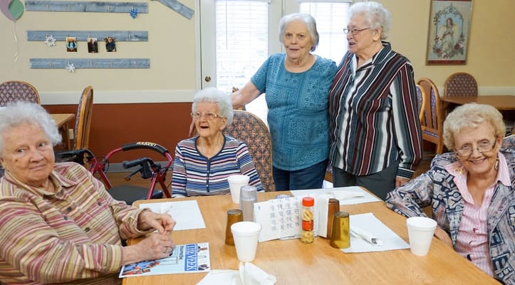 Residents enjoying a social activity in the dining room