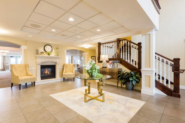 Inviting lobby with seating and fireplace at Peakview Assisted Living