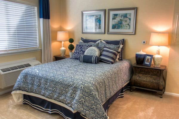 A well-decorated bedroom with a blue and white color scheme.