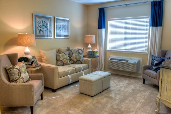 A cozy living room with comfortable seating and decorative pillows.
