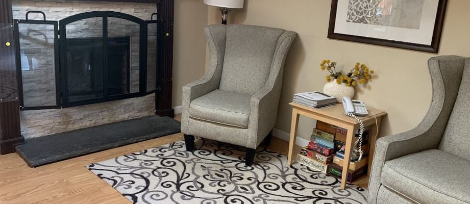 Cozy common area with armchairs and a fireplace